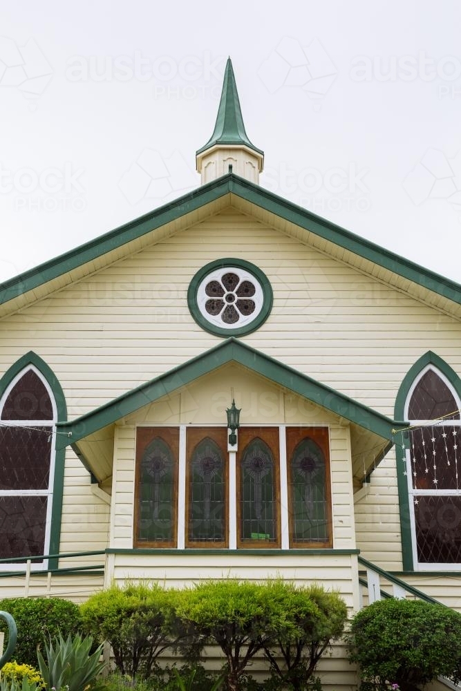 Detail of the entrance to a cream coloured weatherboard church - Australian Stock Image