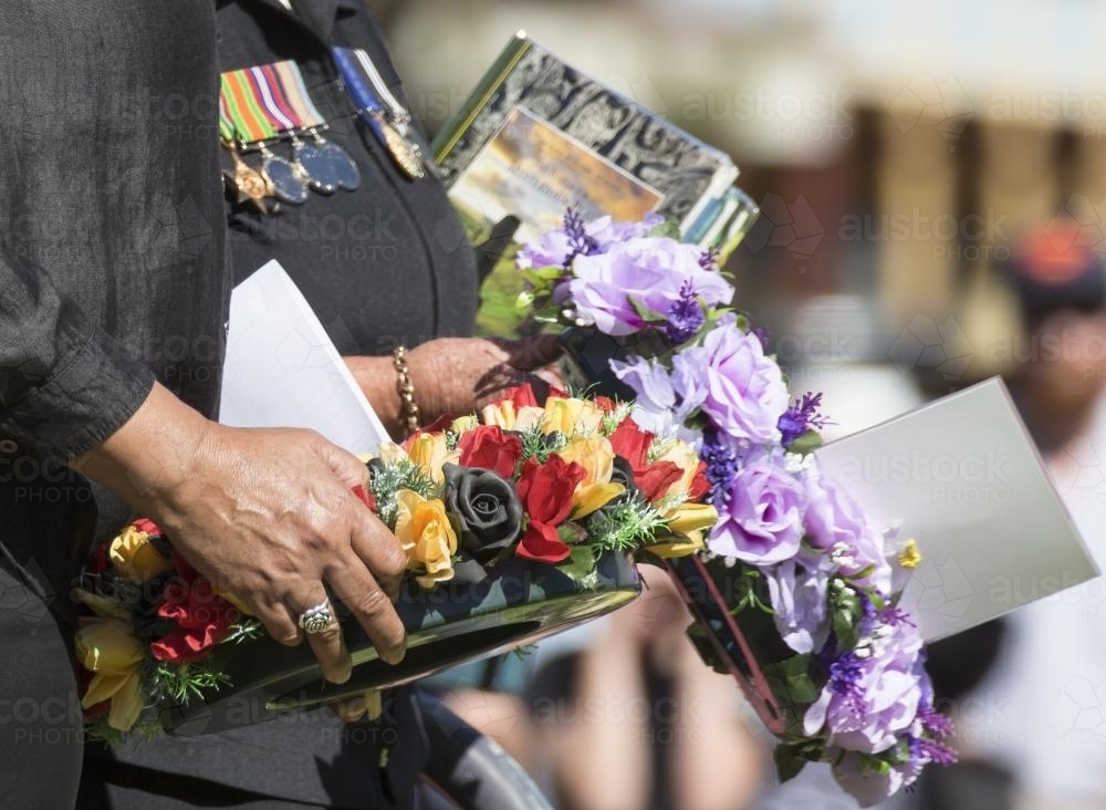 Detail of two people carrying a wreath on ANZAC Day - Australian Stock Image