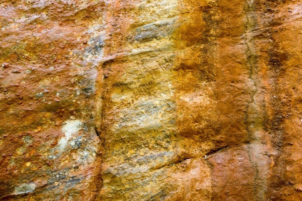 Detail shot of bright orange and yellow rock with texture - Australian Stock Image