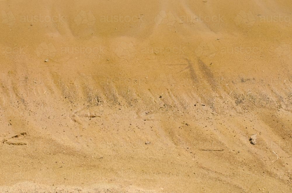 Detail shot of yellow desert sand with patterns and reptile prints - Australian Stock Image