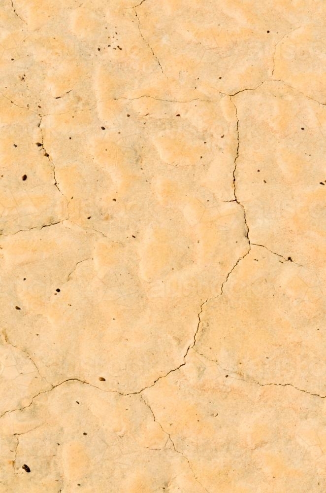 Detail shots of yellow patterned desert claypans with cracks - Australian Stock Image