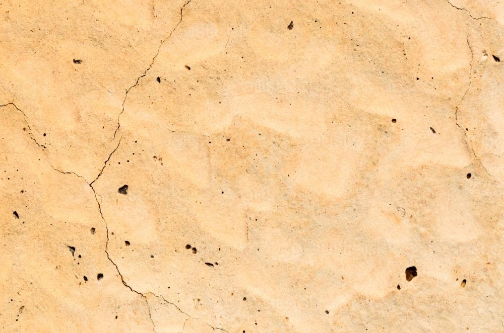 Detail shots of yellow patterned desert claypans with cracks - Australian Stock Image