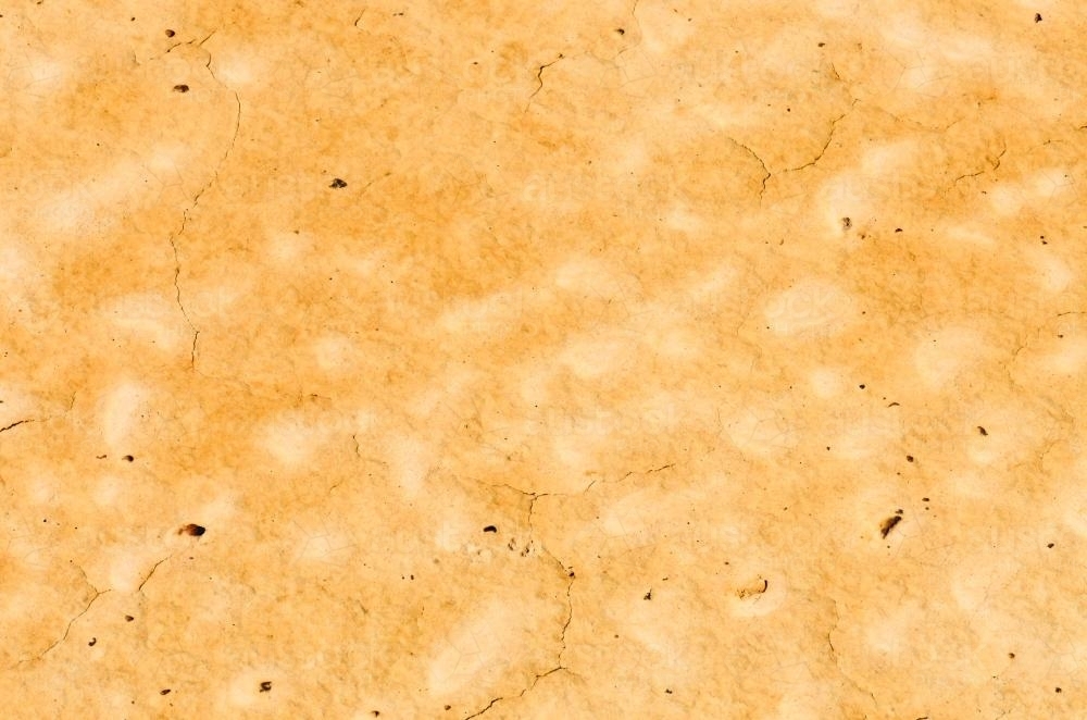 Detail shots of yellow textured and patterned desert claypans with cracks - Australian Stock Image