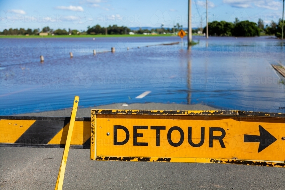 Detour signs blocking a flooded roadway - Australian Stock Image