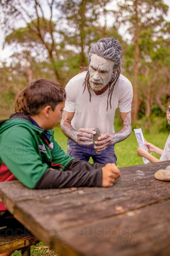dharawal man explaining how sacred rocks were used by previous generations - Australian Stock Image