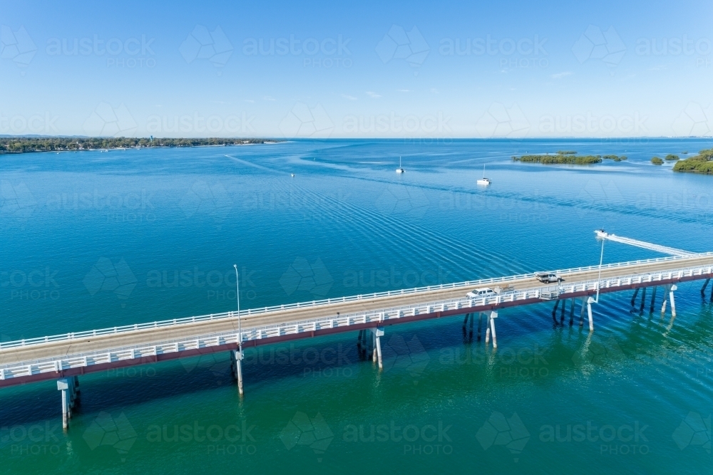 Diagonal aerial view of bridge over water. - Australian Stock Image