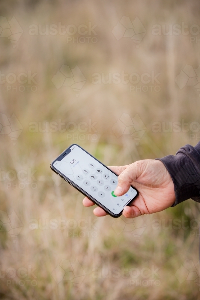 Dialling triple zero on a farm - Australian Stock Image