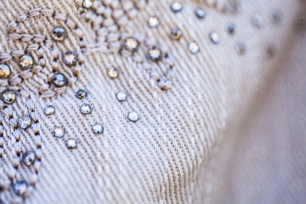 Diamante sparkles and threads making pattern on clothing - Australian Stock Image