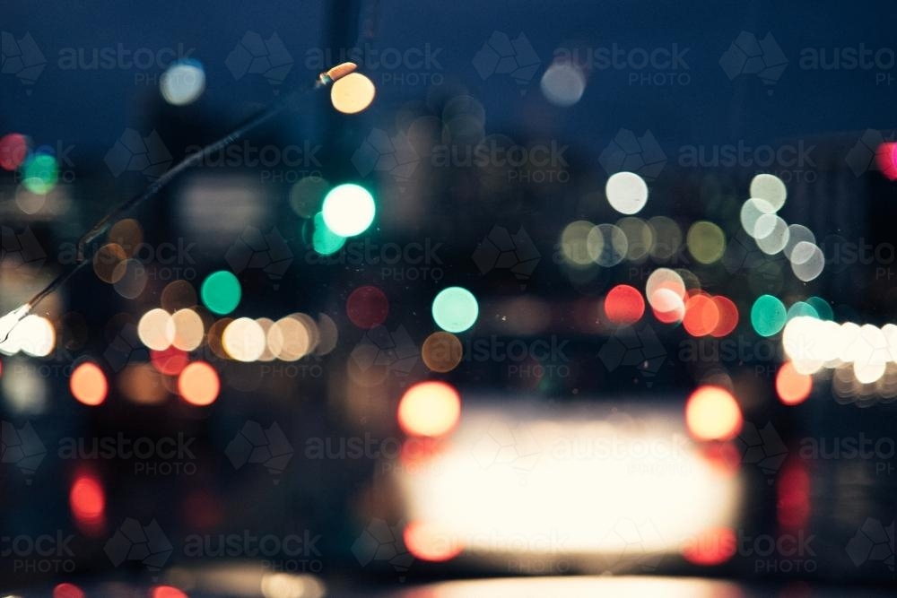 Image of Diffused and blurry car headlights at night in the city