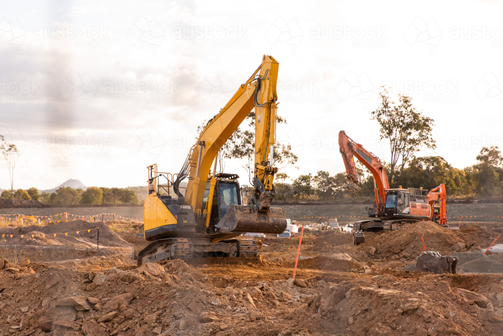 Image of diggers working on getting land ready for a new housing estate ...