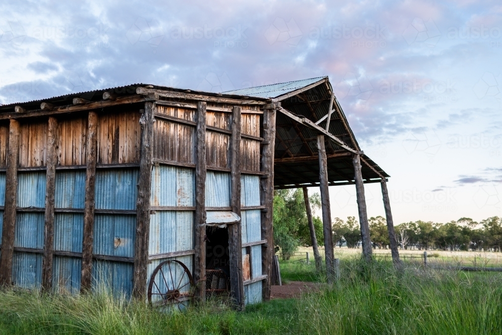 Dilapidated old farm hay shed at dusk on Australian farm - Australian Stock Image