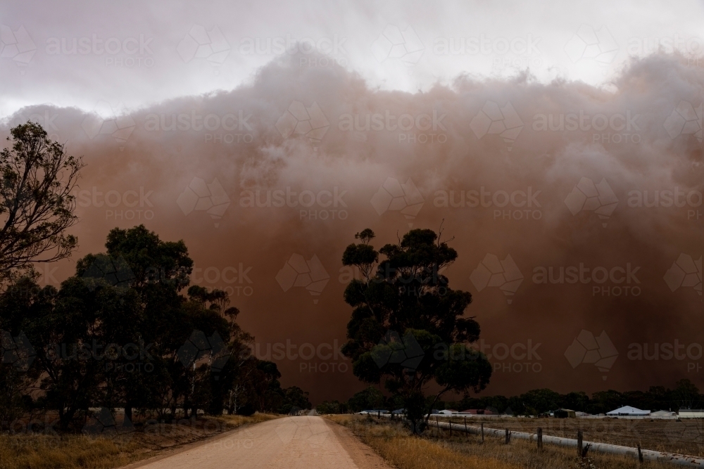 dirt road disappearing in approaching dust storm - Australian Stock Image