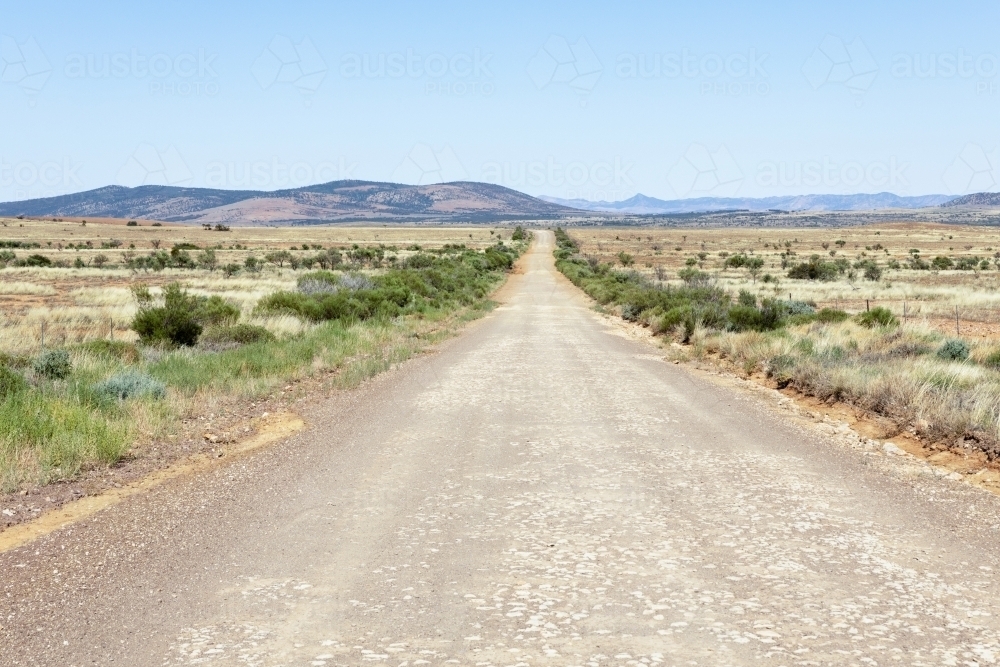 dirt road heading towards distant hills - Australian Stock Image