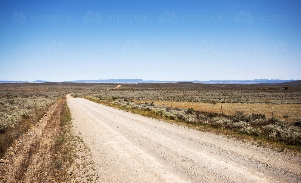 Image Of Dirt Road In An Arid Landscape With Distant Hills Austockphoto
