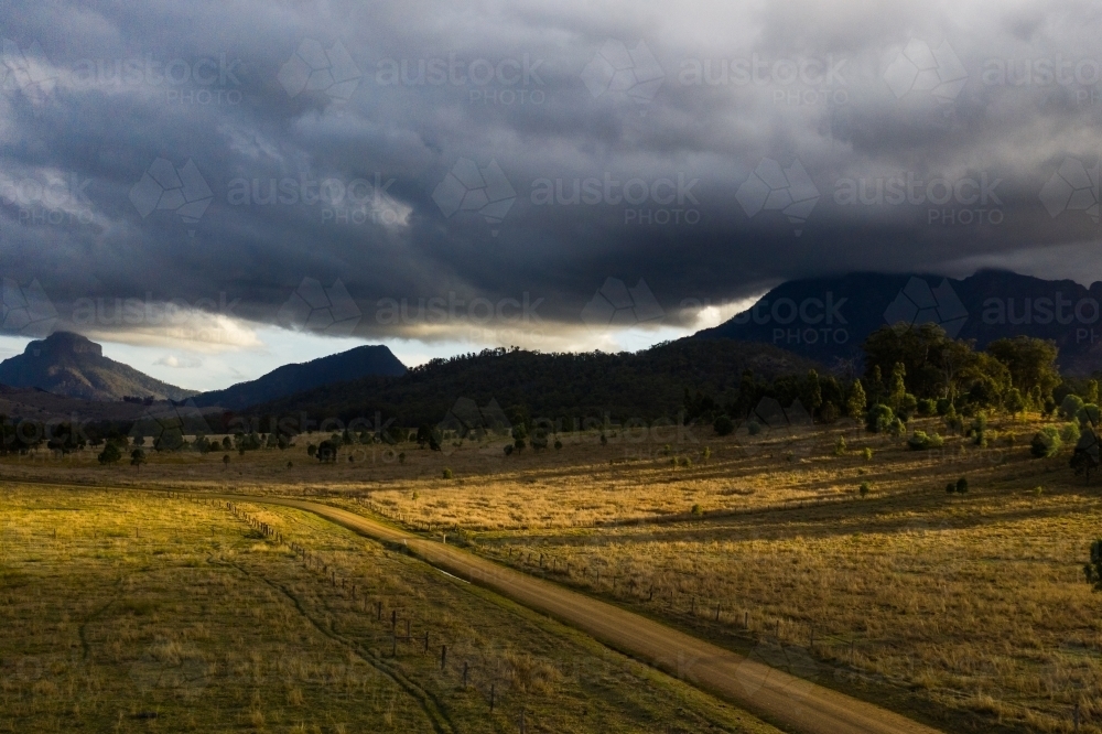 dirt road in front of mountains - Australian Stock Image