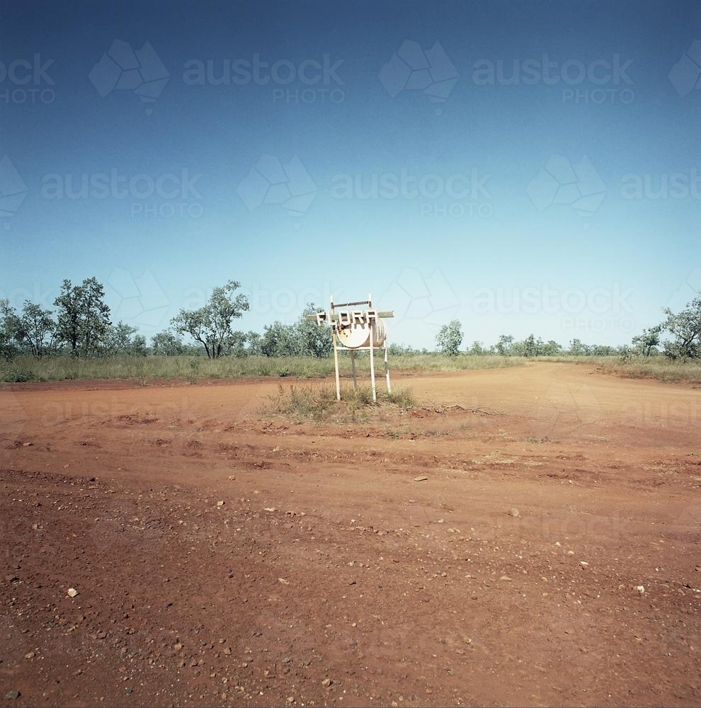Dirt road in remote town with large metal letterbox - Australian Stock Image