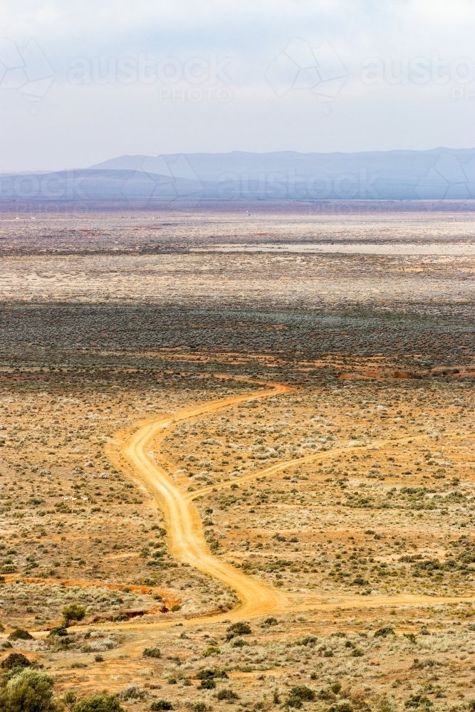 Dirt tracks over saltbush plains - Australian Stock Image