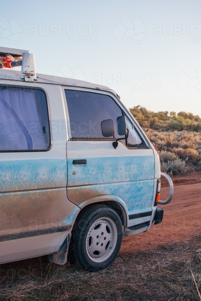 Dirty camper van parked at roadside camp - Australian Stock Image
