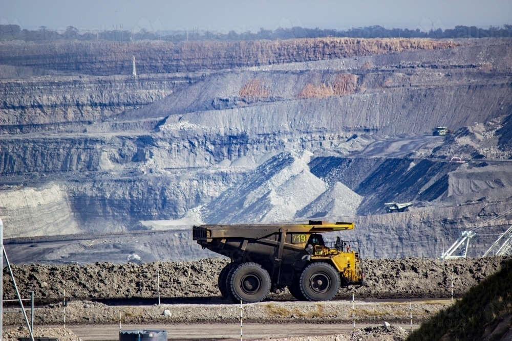 Image of Dirty dump truck driving through open cut coal mine near singleton Austockphoto