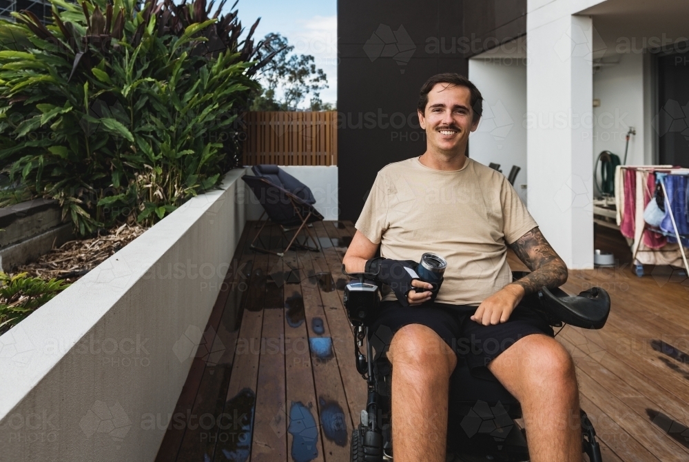 disabled man at home in wheelchair - Australian Stock Image