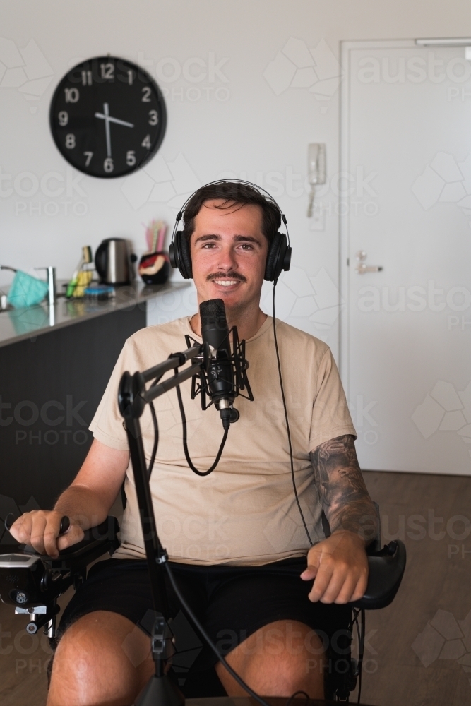 disabled man doing a podcast - Australian Stock Image