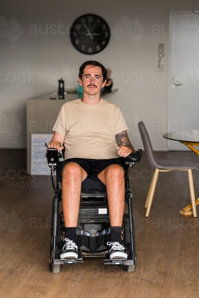 disabled man in motorised wheelchair - Australian Stock Image