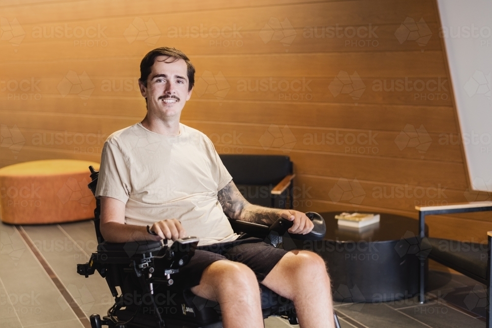 disabled man in motorised wheelchair - Australian Stock Image