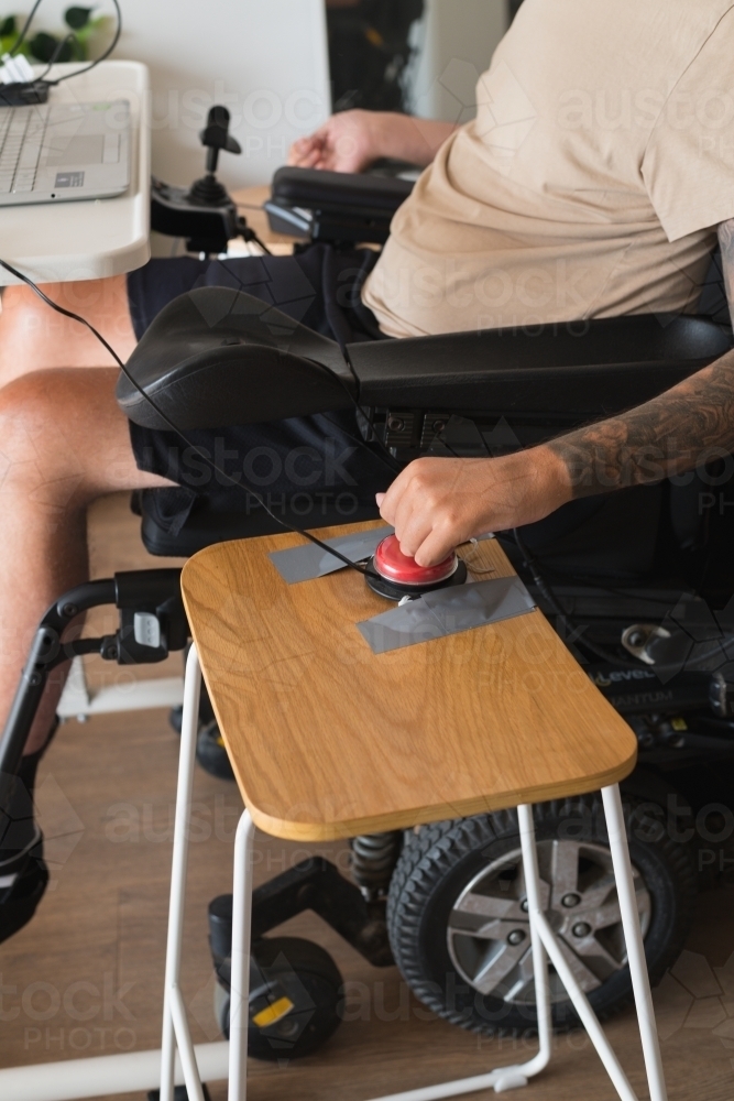 disabled man using computer, with special adaptive devices - Australian Stock Image