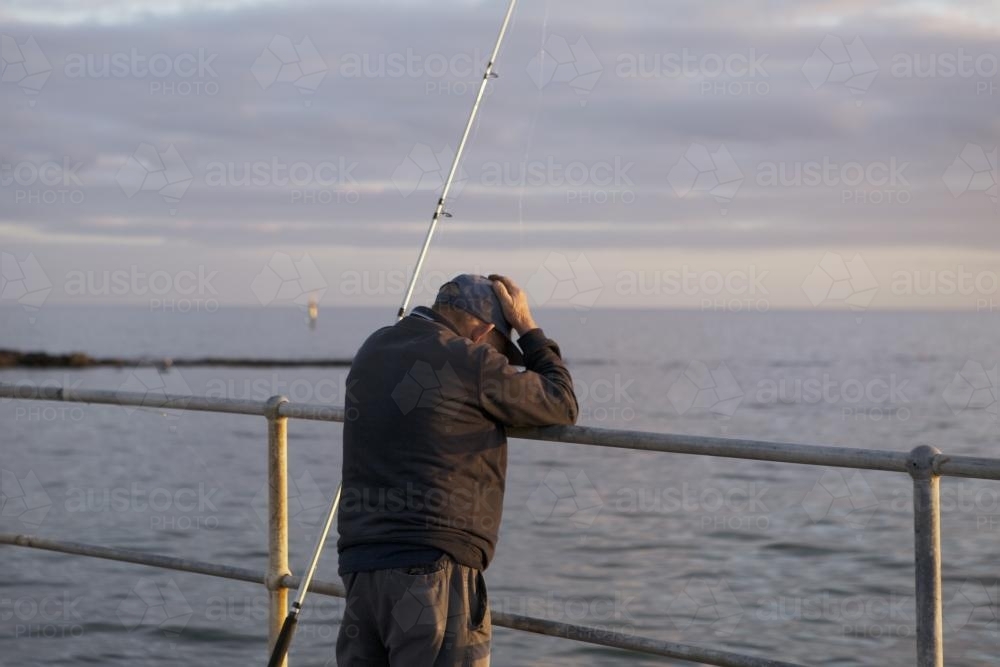Disappointed fisherman from behind - Australian Stock Image