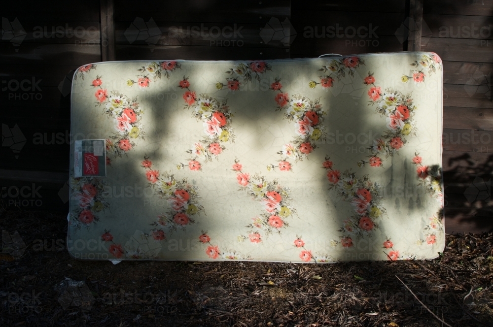 Discarded floral mattress - Australian Stock Image