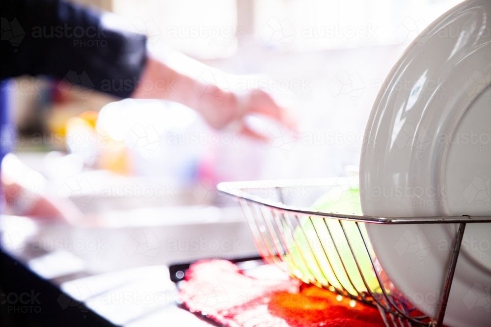 Dishes drying in dish rack - Australian Stock Image
