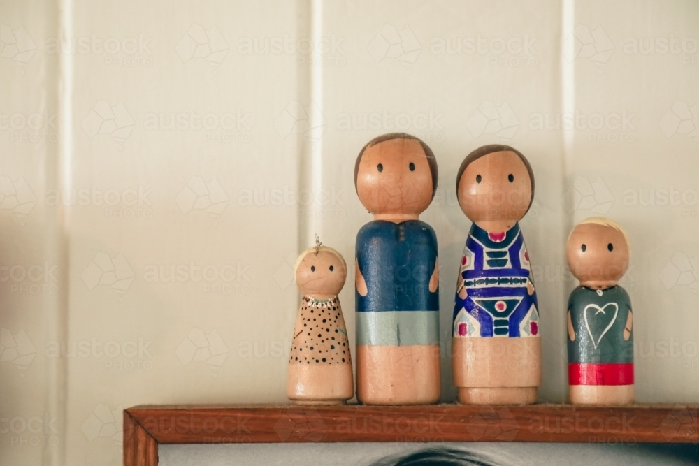 Display of wooden family figurines with white background. Nuclear family - Australian Stock Image