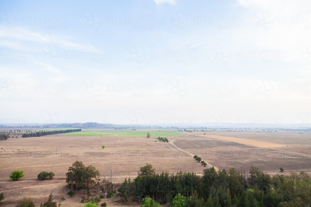 Distant paddock landscape with smokey sky - Australian Stock Image