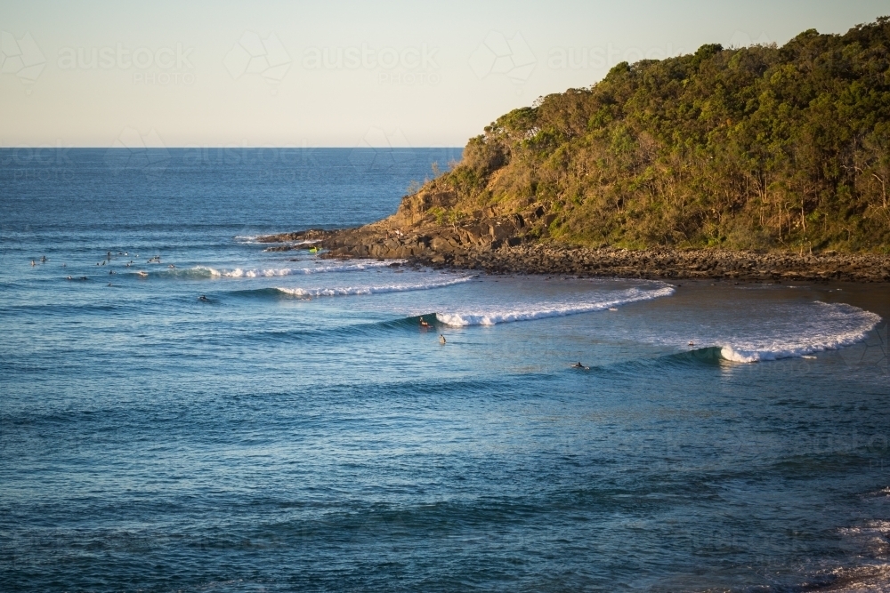 Distant surfers in the ocean - Australian Stock Image