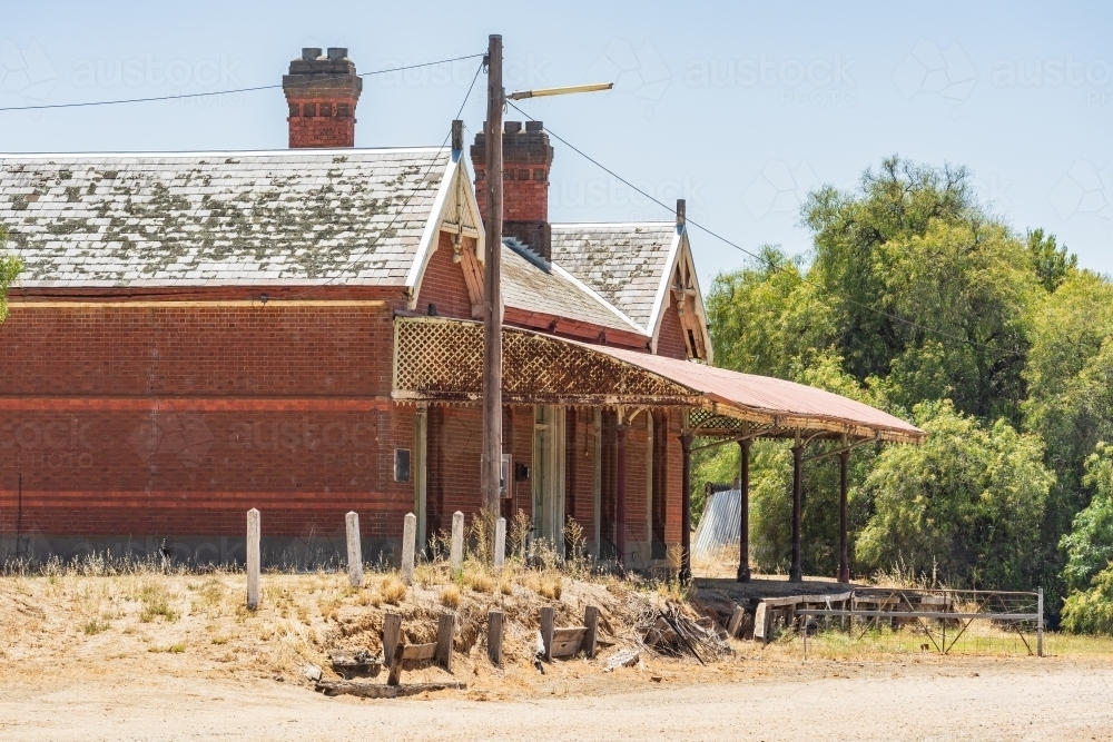 Distant view of an abandoned railway station with veranda and platform - Australian Stock Image
