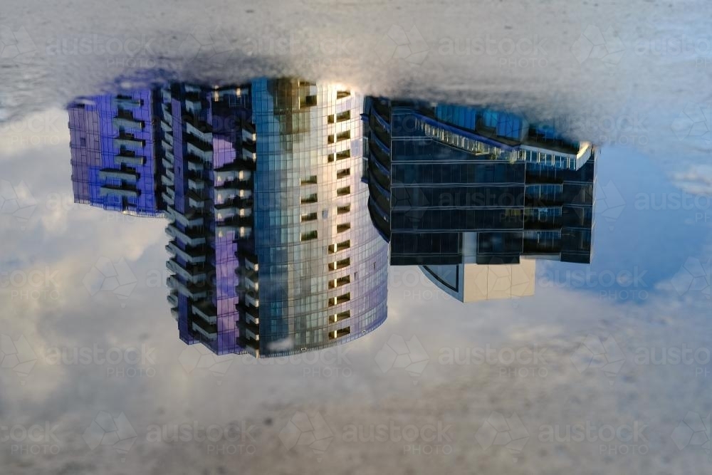 Docklands Apartment Buildings Reflected in a Puddle - Australian Stock Image