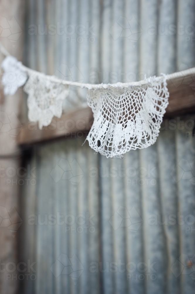 doily bunting in a rustic tin shed - Australian Stock Image