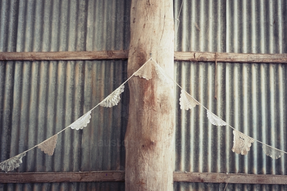doily bunting in a rustic tin shed - Australian Stock Image