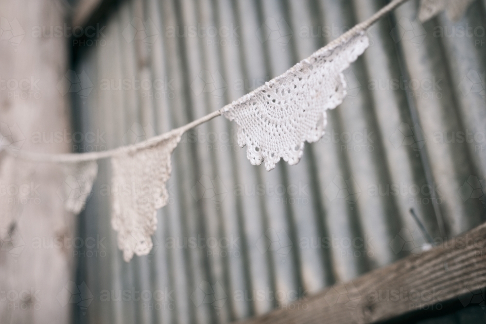 doily bunting in a rustic tin shed - Australian Stock Image