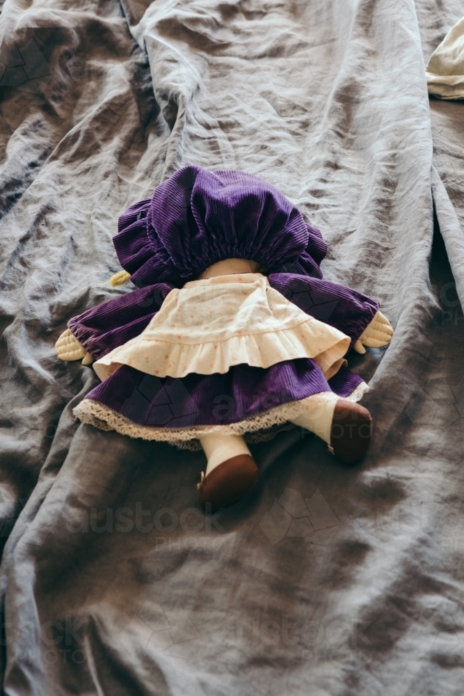 Doll face down on a bed representing drunk, tired or abandoned : Austockphoto Doll face down on a bed representing drunk, tired or abandoned - Australian Stock Image