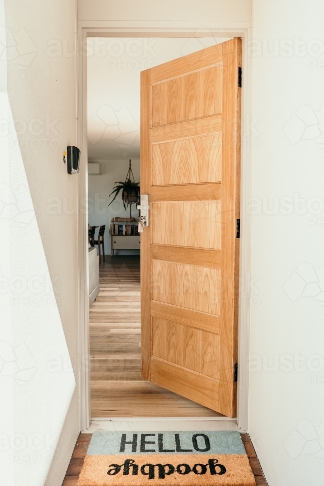 Doorway to a house with welcome mat. - Australian Stock Image