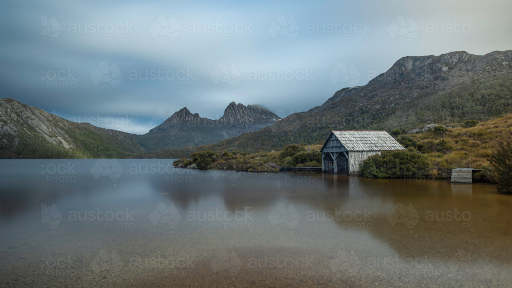 Dove Lake Boathouse with Cradle Mountain in the distance - Australian Stock Image