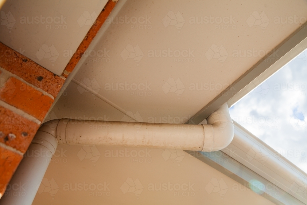 Down pipe coming from gutter to collect rain - Australian Stock Image