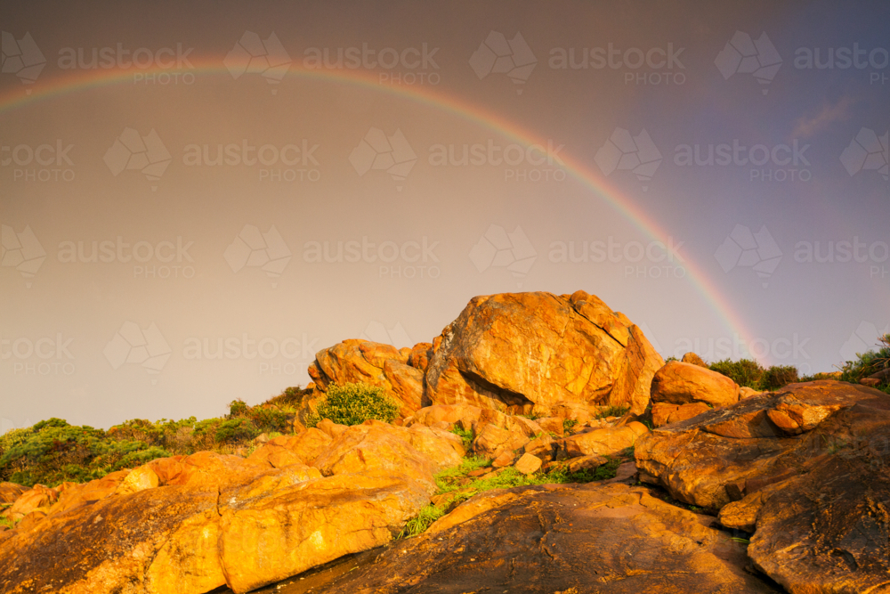 Rainbow Rocks Outside Image of Dramatic storm lighting and a rainbow over colourful coastal ...
