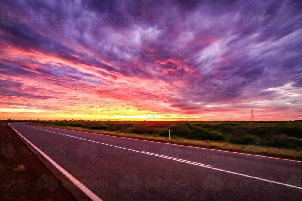 Dramatic sunrise over outback road - Australian Stock Image