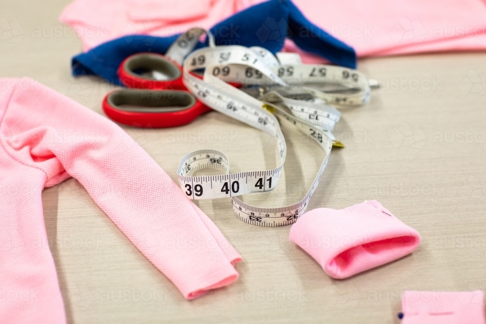 dressmaking supplies with tape measure and scissors - Australian Stock Image