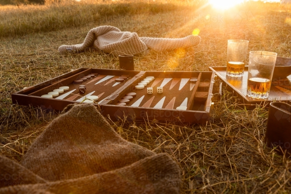 Drinks and a game of backgammon on the grass in the afternoon sun - Australian Stock Image