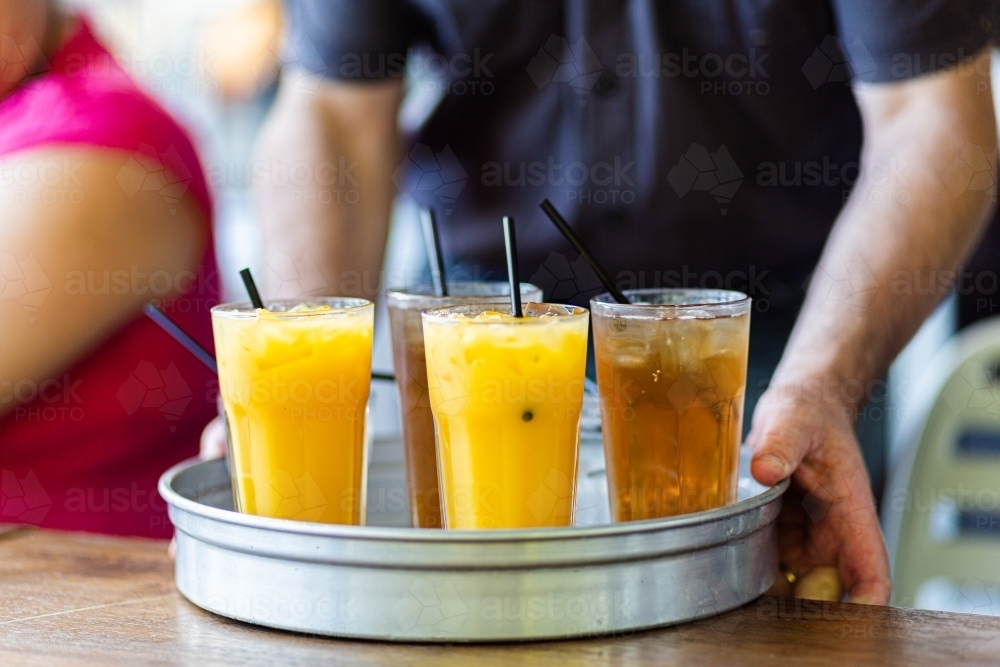 Drinks being served on tray at pub orange juice and ginger ale - Australian Stock Image