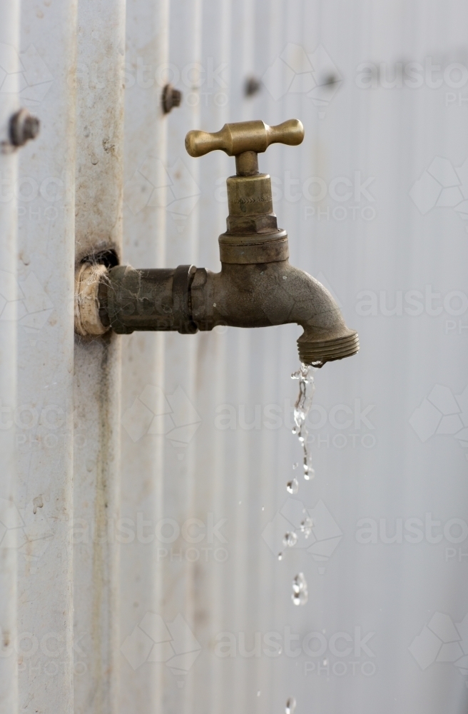 Dripping tap on currugated tin shed - Australian Stock Image