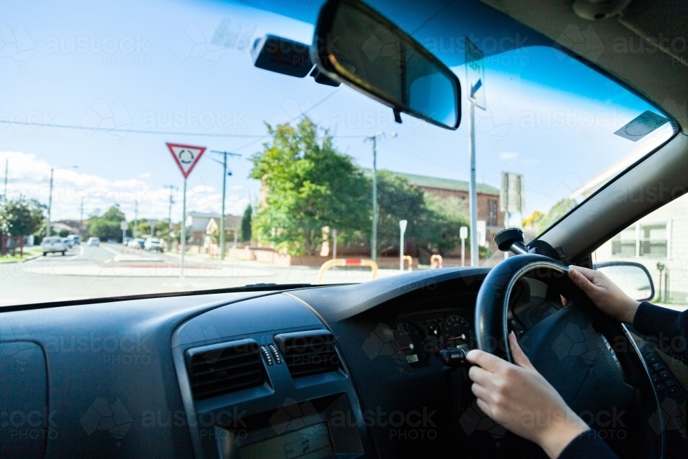 Driver going around a round about in the city - Australian Stock Image